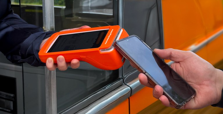 Customer making contactless payment with portable card machine Ireland mobile trader