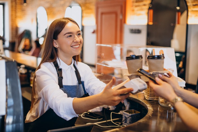 Waiter using PAX A920 PRO payment terminal for payment processing Ireland restaurant