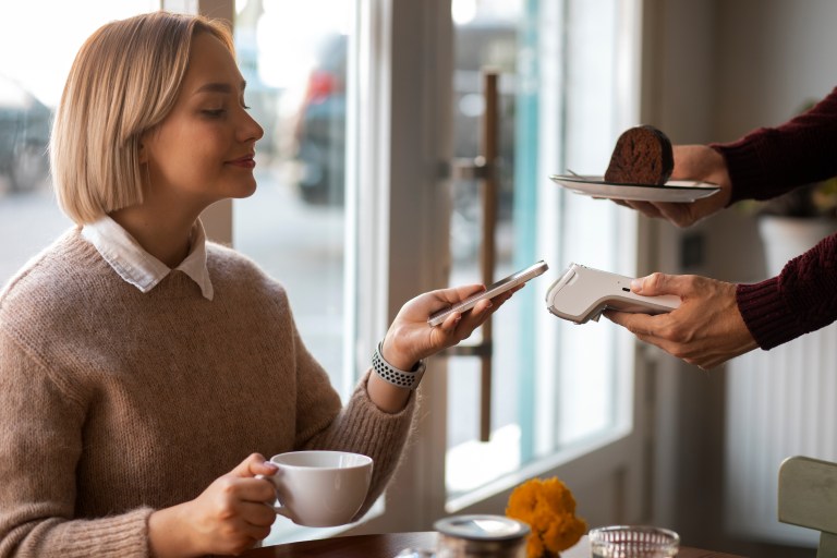 Customer making contactless payment on portable card machine UK easyPro terminal