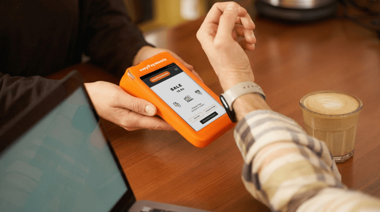 Customer making a contactless payments UK on an easyPayments card machine using a smart watch