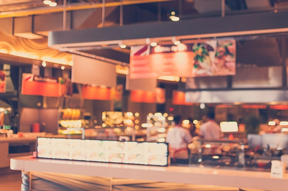 Person at a store counter accepting cashless payments in an Irish small business